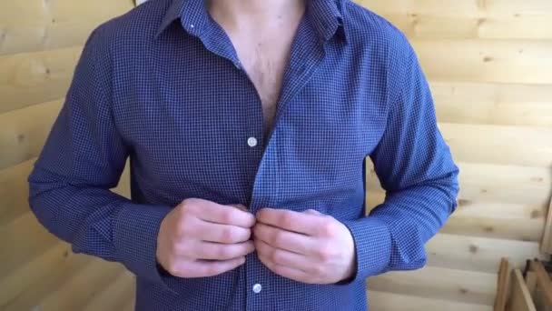 The young man unbuttoned blue shirt — Stock Video