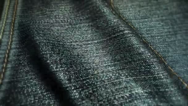 Realistic jeans waving in the wind. Abstract background Ultra-HD resolution. Close-up fabric texture. Seamless loop — Stock Video