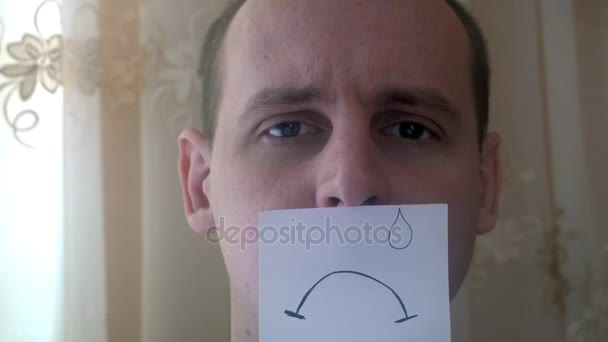 Jeune homme montre ses émotions avec un morceau de papier — Video