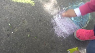 Bebek el ile renkli tebeşirler kaldırımda çizimi