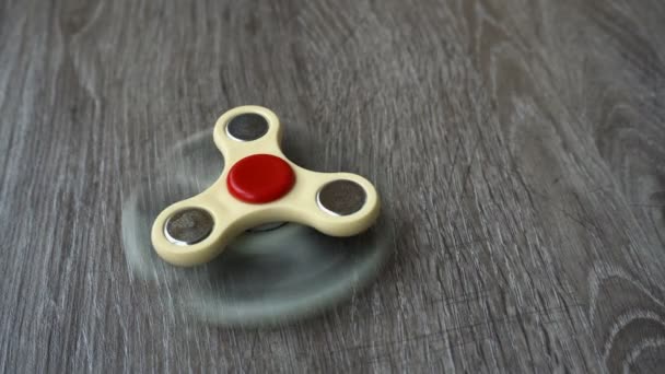 Two white hand spinner spinning on grey background or fidget spinners — Stock Video