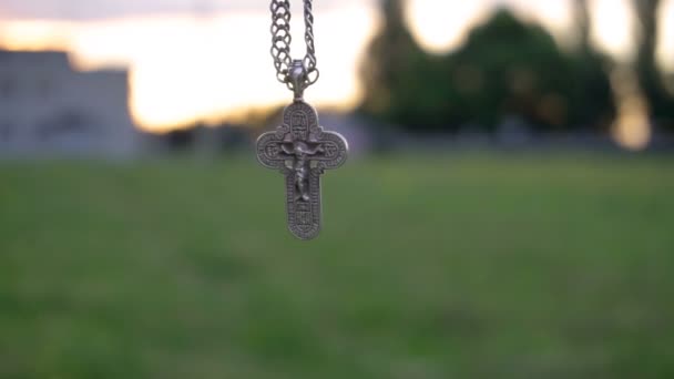 Christian cross on a chain on the background of sunrise — Stock Video