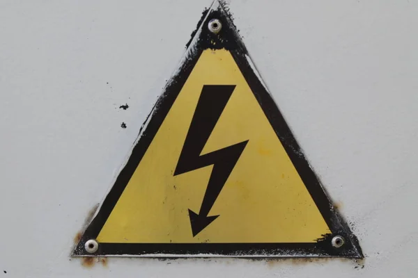 Black and yellow danger warning sign. Attention — Stock Photo, Image