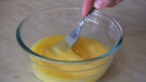 Mixing eggs in bowl with a fork — Stock Video