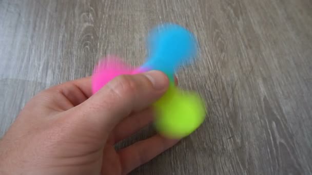 Playing with the colorful Fidget Spinner. Toy spinner in hand — Stock Video