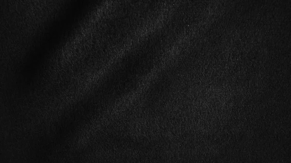 Schwarzer Stoffhintergrund abstrakt mit weichen Wellen. — Stockfoto