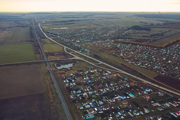 View of the city and the road, top view, suburb and fields