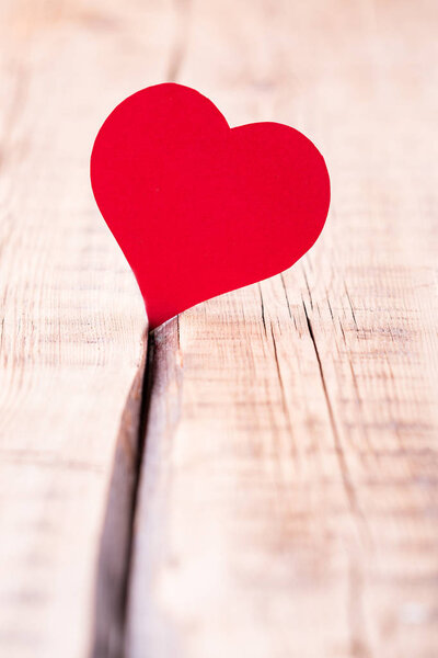 red heart, paper, wooden background