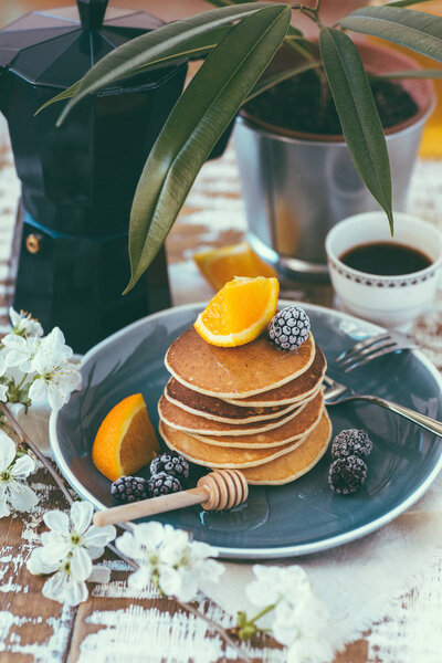 pancakes, a pile, a blue plate, a blue coffee pot, an American breakfast, a still-life