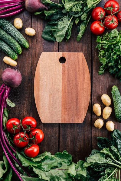 cutting board around vegetables, food frame, wooden background