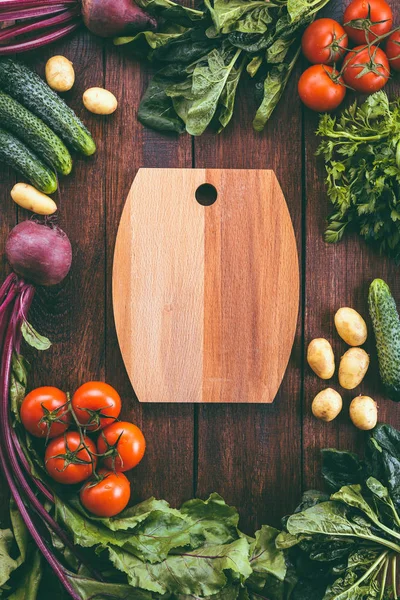 cutting board around vegetables, food frame, wooden background