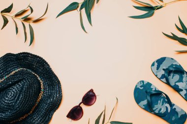 Yaz arkaplanı, siyah hasır şapka, güneş gözlüğü ve terlik, pastel ton, fotokopi alanı
