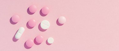 Pembe kağıtta haplar arka planda, uzun afiş