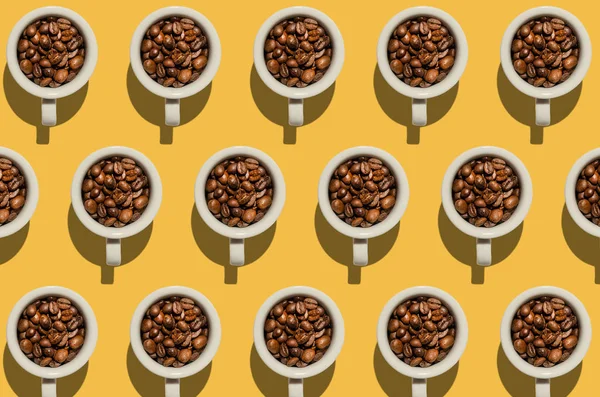 Pattern. Cup with coffee beans concept. Group of white cups on y