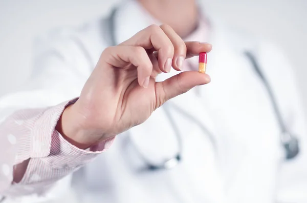 Крупним планом одна таблетка в руках лікаря — стокове фото