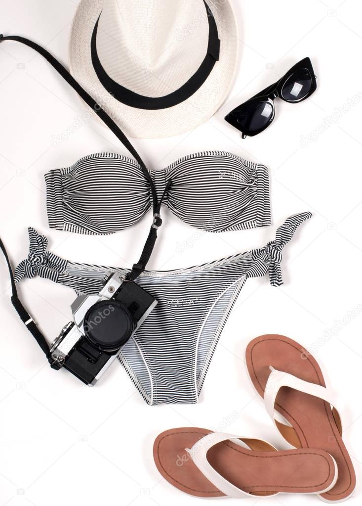 Female swimsuit beach accessories on white background. 