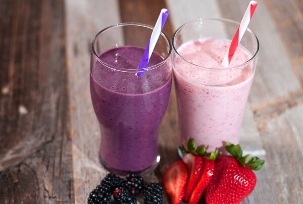 Milkshakes made with fresh blueberries and strawberries in a glass 