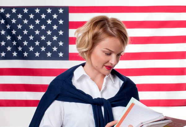 Student is learning English as a foreign language on American flag  background