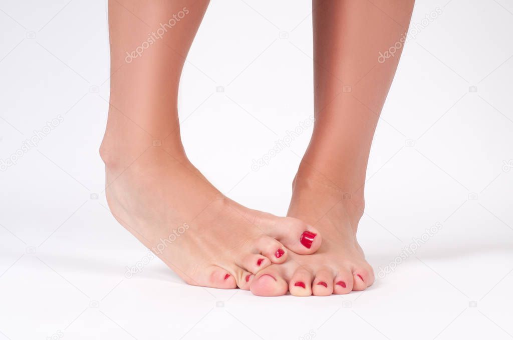  Foot fungus. Female feet on white background.