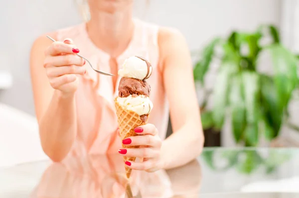 Woman eating chocolate ice cream cone. — Stock Photo, Image