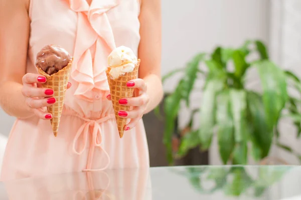 Woman eating chocolate ice cream cone.