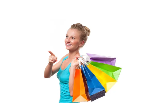 Joyeux shopaholic fille avec des sacs à provisions colorés, sur fond blanc — Photo