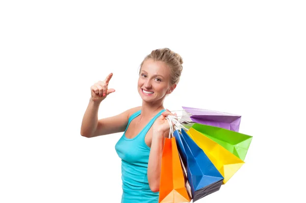 Joyeux shopaholic fille avec des sacs à provisions colorés, sur fond blanc — Photo