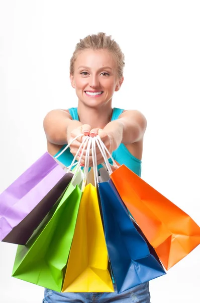 Happy girl shopaholic with colored shopping bags, on white background — Stock Photo, Image