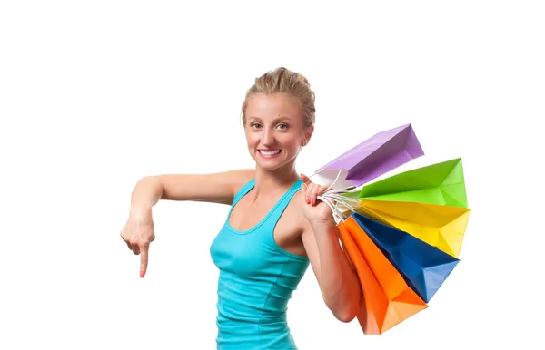 Joyeux shopaholic fille avec des sacs à provisions colorés, sur fond blanc — Photo