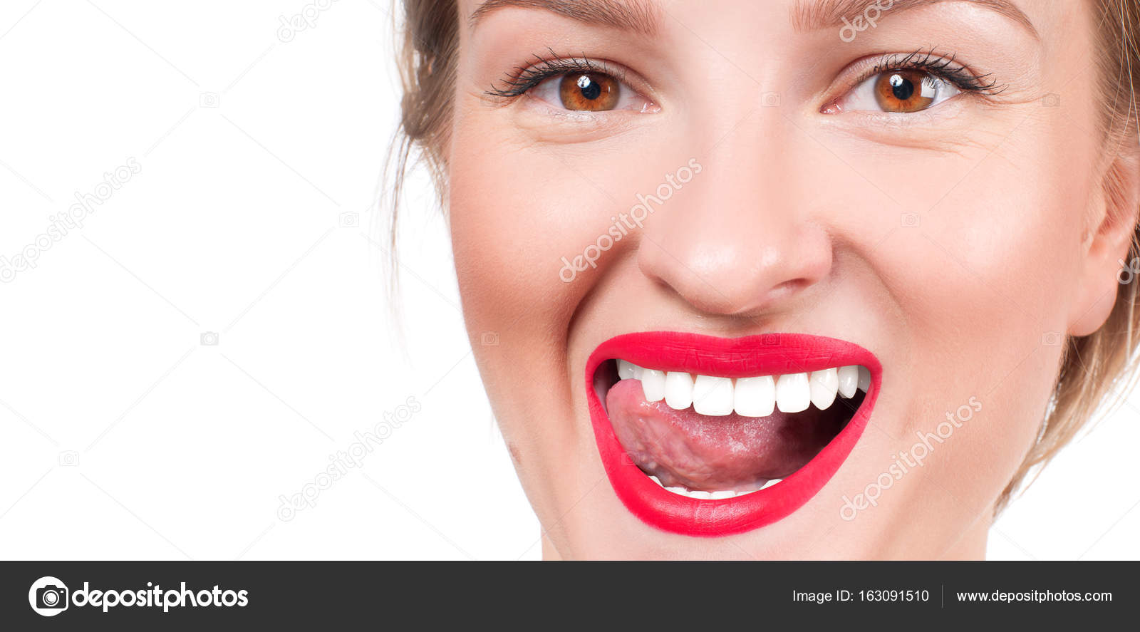 White teeth and red lips. Perfect female smile after whitening teeth