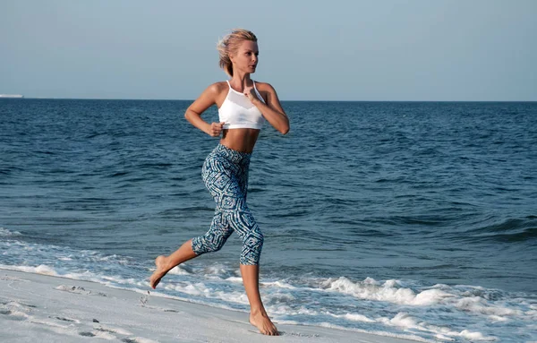 Corredor mujer corriendo en la playa al atardecer — Foto de Stock