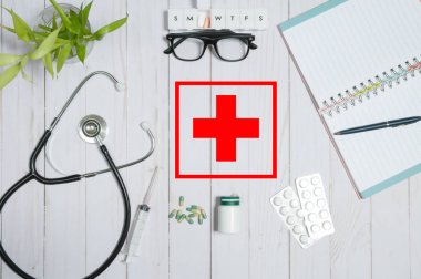 Doctor table with medical items, stethoscope and pills clipart