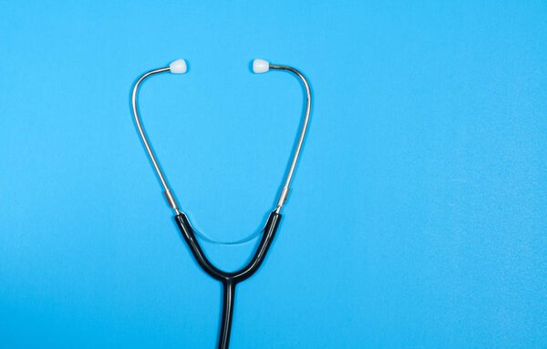 Medical stethoscope on blue background.