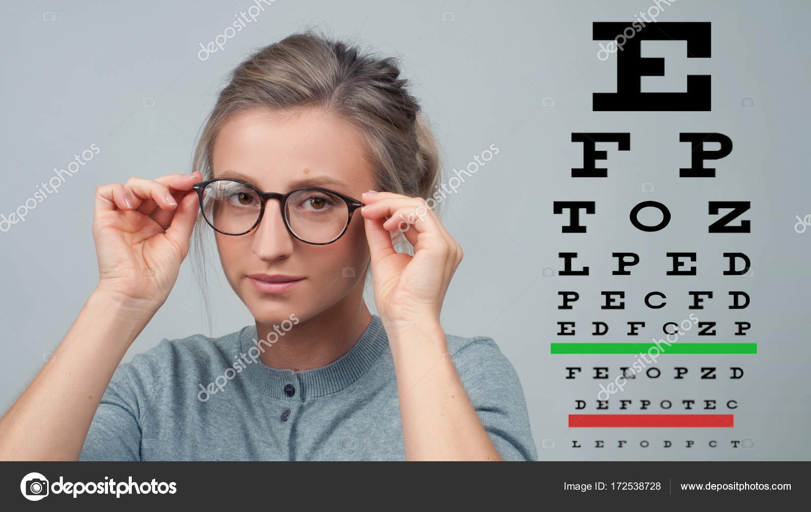 Eyesight Woman in glasses on the background of eye test