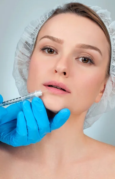 Menina bonita recebendo injeção de enchimento nos lábios. Cirurgia Plástica . — Fotografia de Stock