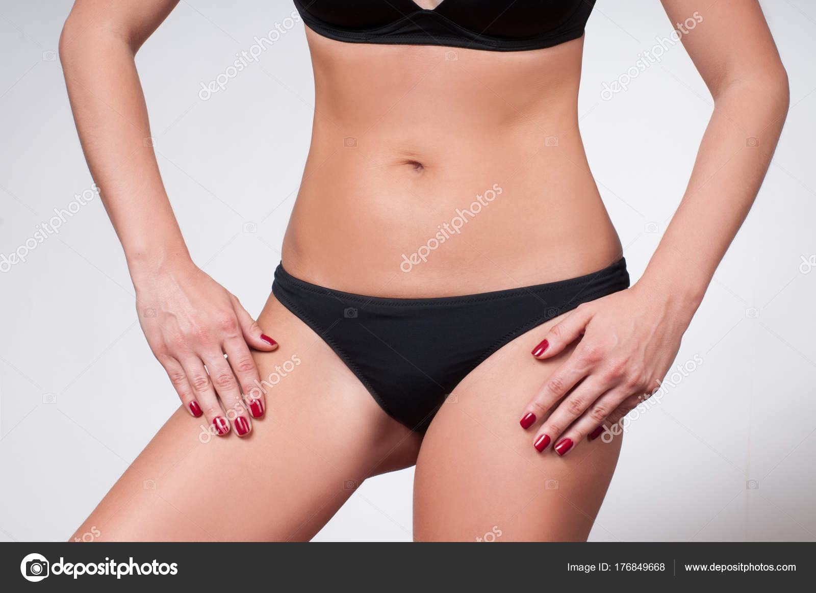 Femine beauty lines concept. Slim woman with dark skin flat stomach wears  high waist panties and bra Stock Photo by wayhomestudioo