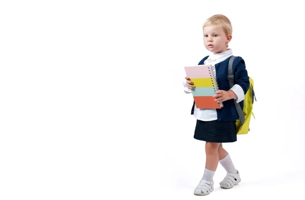 Happy little schoolgirl. Child with backpack and books. — Stock Photo, Image