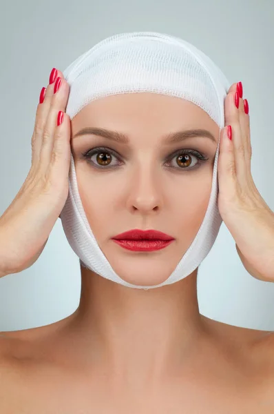 Beautiful woman after plastic surgery with bandaged face. Beauty, Fashion and Plastic Surgery concept — Stock Photo, Image
