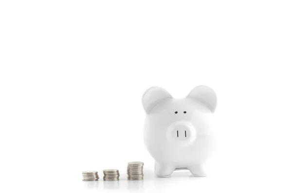 White piggy bank and coins isolated on white — Stock Photo, Image
