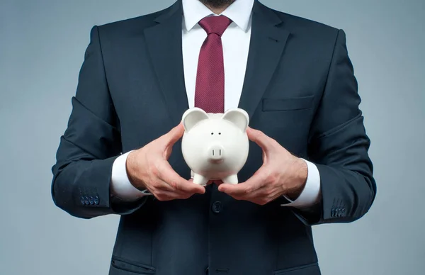Finance Savings concept. Businessman in suit is holding piggy bank. — Stock Photo, Image
