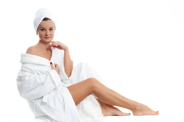 Spa. Beautiful girl in bathrobe.  Smooth female legs after depilation. — Stock Photo, Image