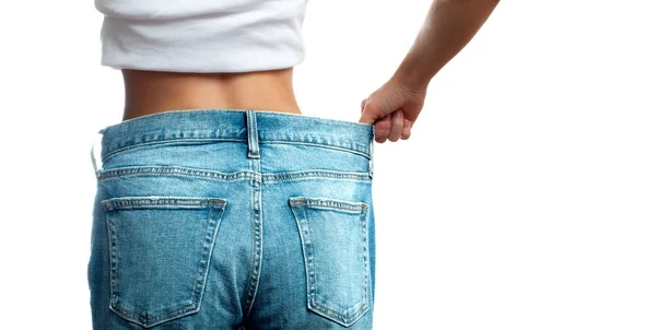 Donna in jeans oversize dopo la perdita di peso, concetto di dieta . — Foto Stock