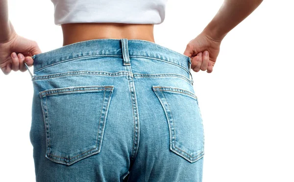 Woman in oversize jeans after weight loss, diet concept. — Stock Photo, Image