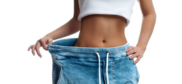 Mulher em jeans de tamanho grande após a perda de peso . — Fotografia de Stock