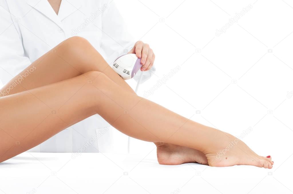 Beautician removing hair of woman's leg.  Laser depilation 