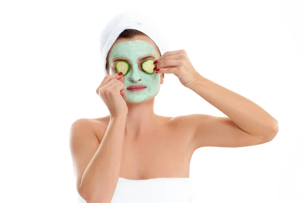 Beautiful woman with clay mask and cucumber on white background. Beauty and spa — Stock Photo, Image