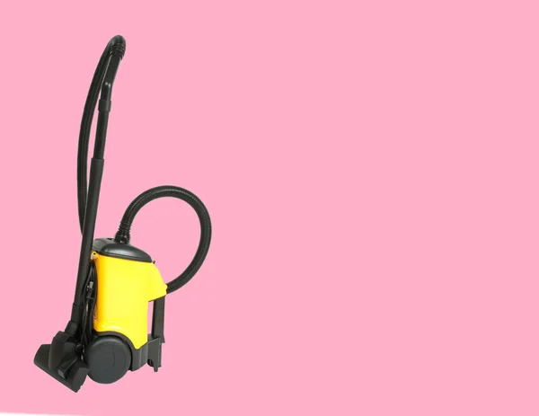 Vacuum cleaner on pastel pink background
