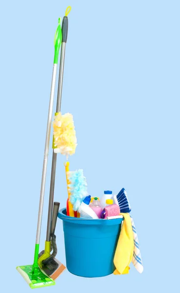 Cleaning supplies in blue bucket on pastel background — Stock Photo, Image