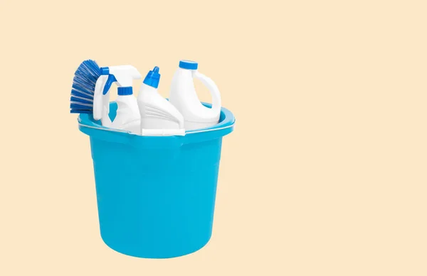 Cleaning supplies in blue bucket on pastel background — Stock Photo, Image