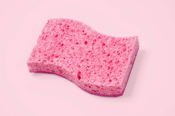 Pink sponge on pastel pink background — Stock Photo, Image